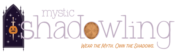 A Halloween-themed graphic banner with the words 'mystic shadowing' in lavender and orange text, plus the tagline 'WEAR THE MYTH. OWN THE SHADOWS.